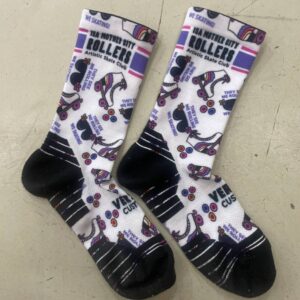 Pair of white and black socks with roller skate designs in purple